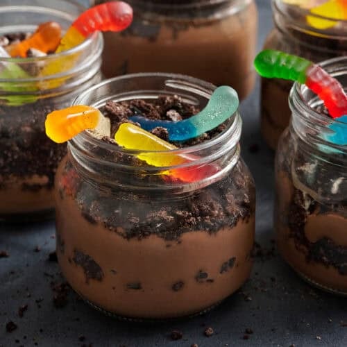 Side view of a worms in dirt dessert pudding cup.