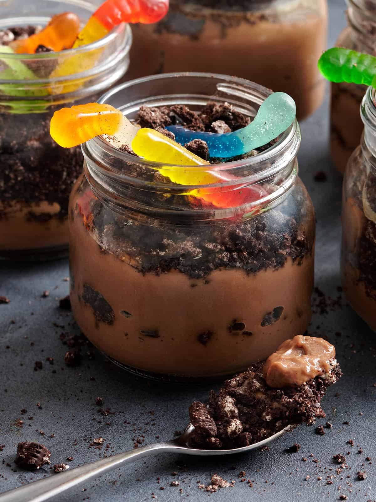 Side view of a worms in dirt dessert cup.