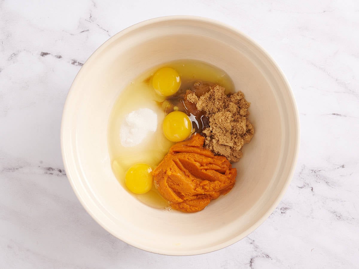 pumpkin roll cake batter ingredients in a bowl