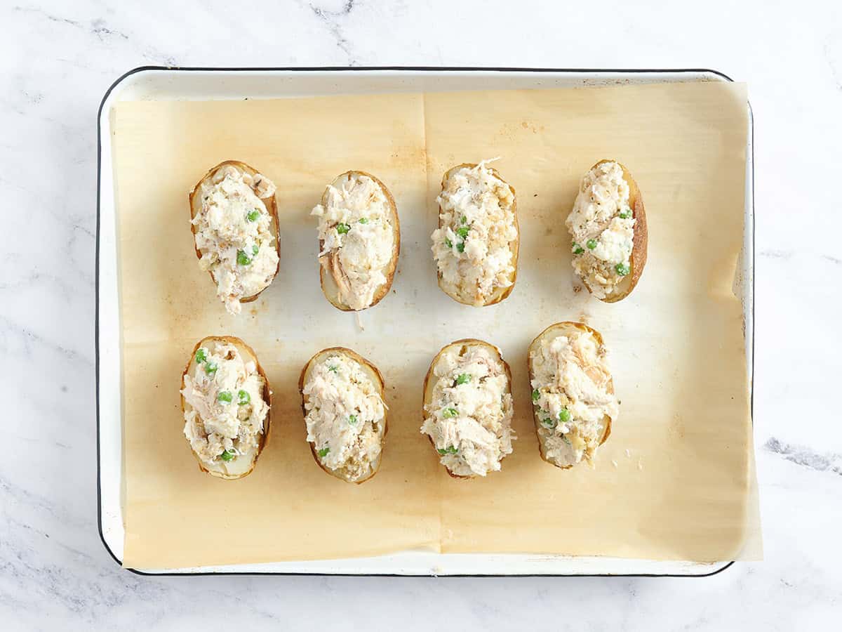 Stuffed potato skins on a baking sheet.