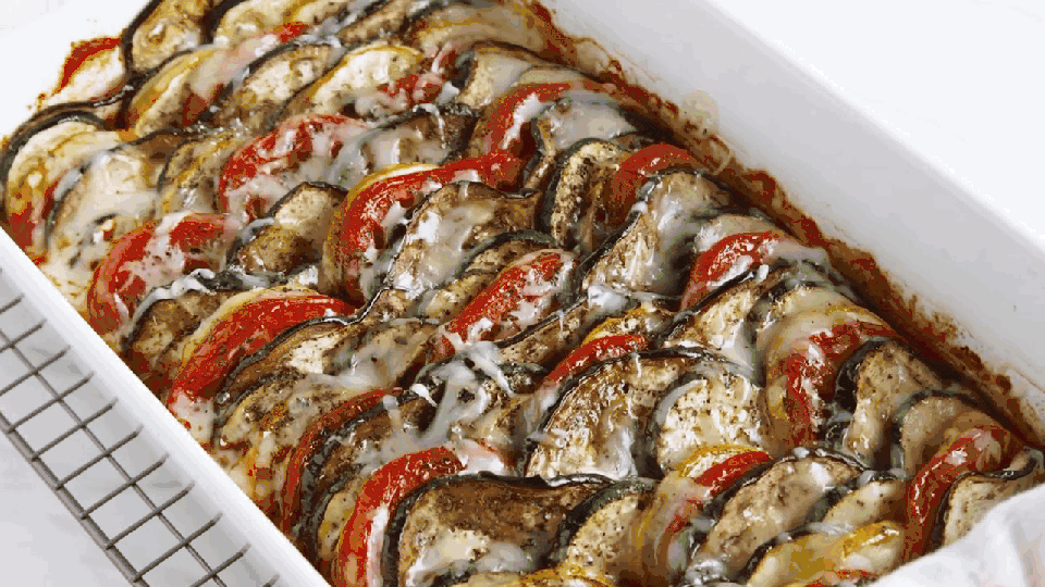 ratatouille being topped with parsley