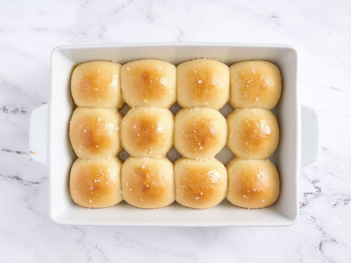 Baked rolls in a white pan.