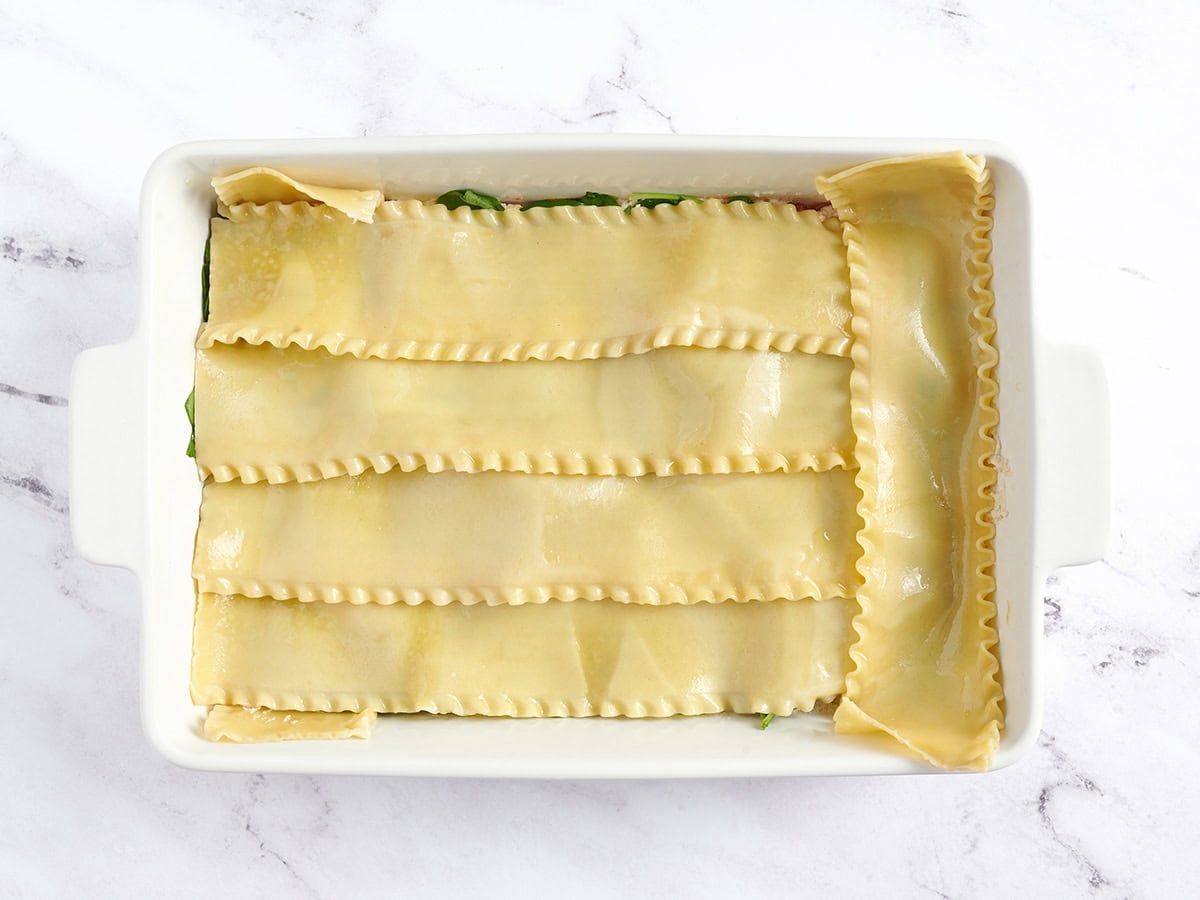 Lasagna noodles added to casserole dish.