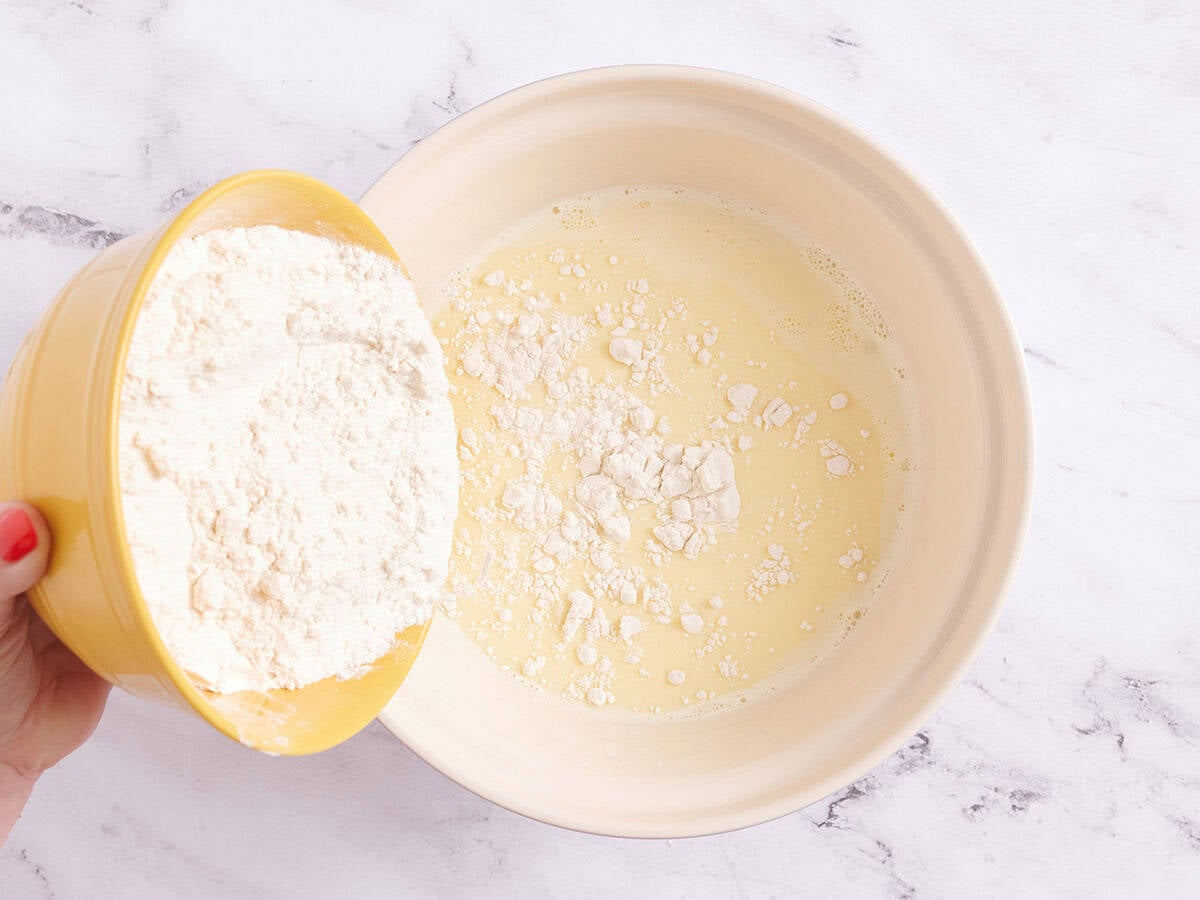 Adding flour to the milk mixture.