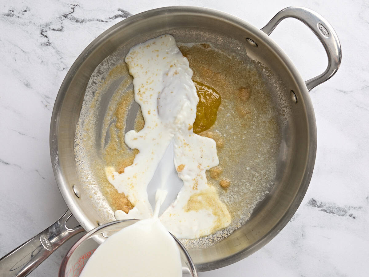Chicken bouillon and cream in a sauce pan.
