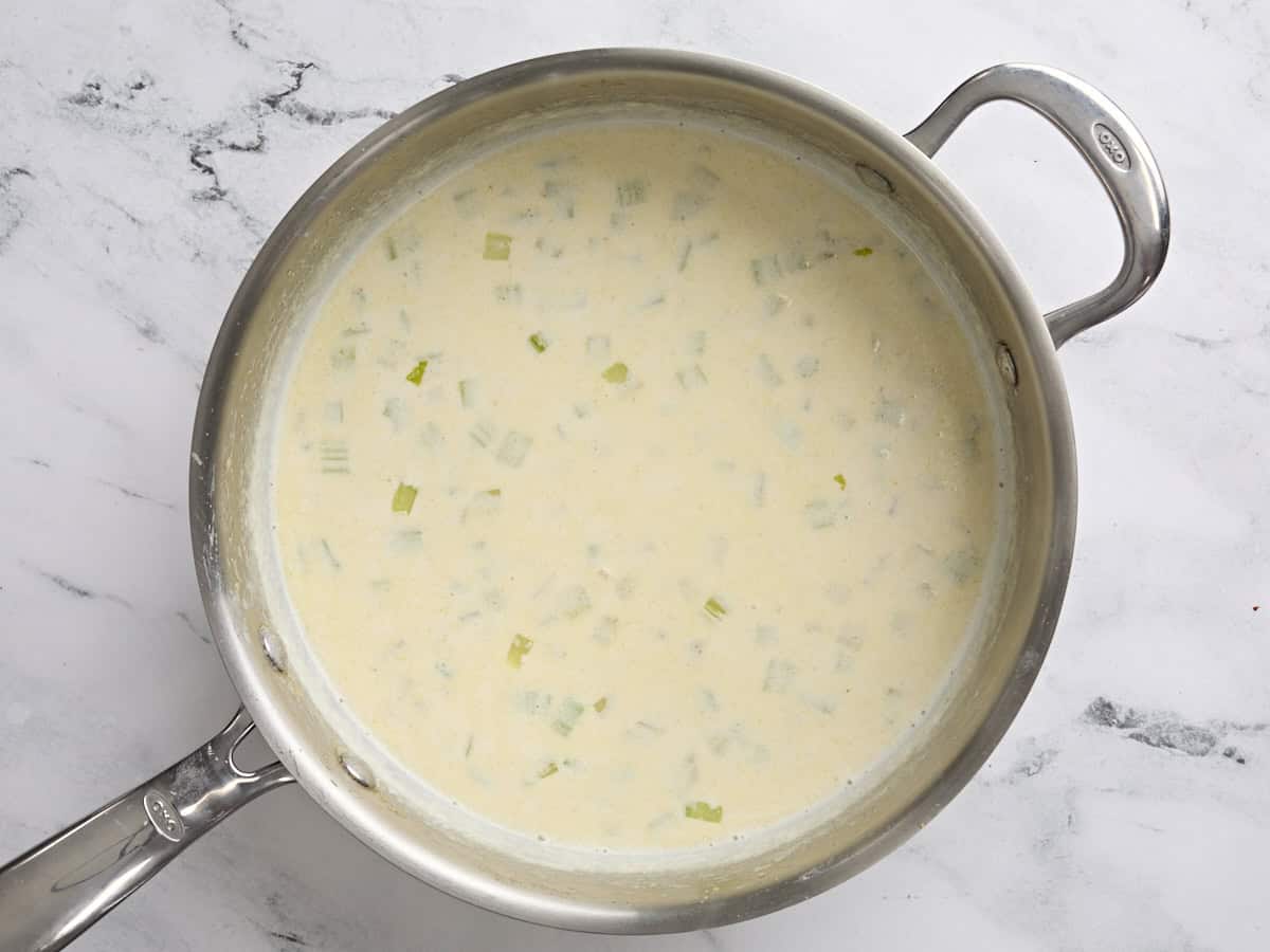 A sauce pan of homemade cream of celery soup.