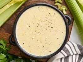 Overhead view of a bowl of homemade cream of celery soup.