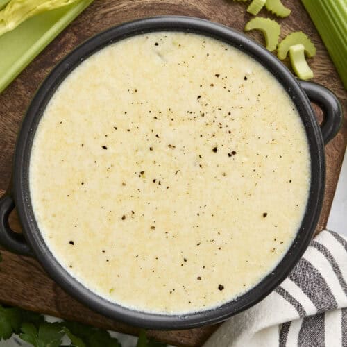 Overhead view of a bowl of homemade cream of celery soup.