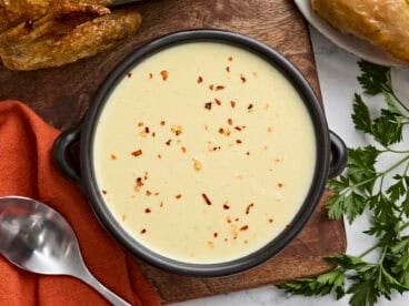 Overhead view of a bowl of cream of chicken soup.