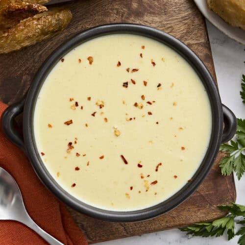 Overhead view of a bowl of cream of chicken soup.