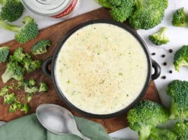 Overhead view of a bowl of homemade cream of broccoli soup.