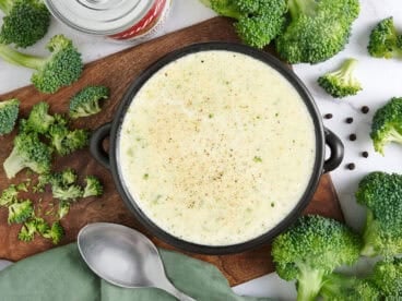 Overhead view of a bowl of homemade cream of broccoli soup.