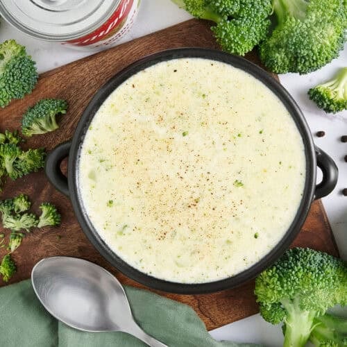 Overhead view of a bowl of homemade cream of broccoli soup.