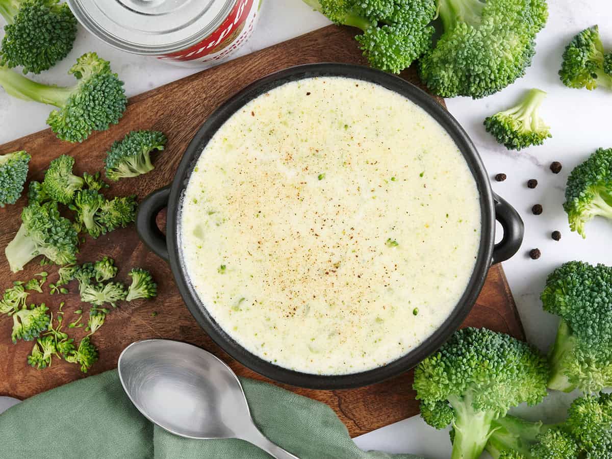 Overhead view of a bowl of homemade cream of broccoli soup.
