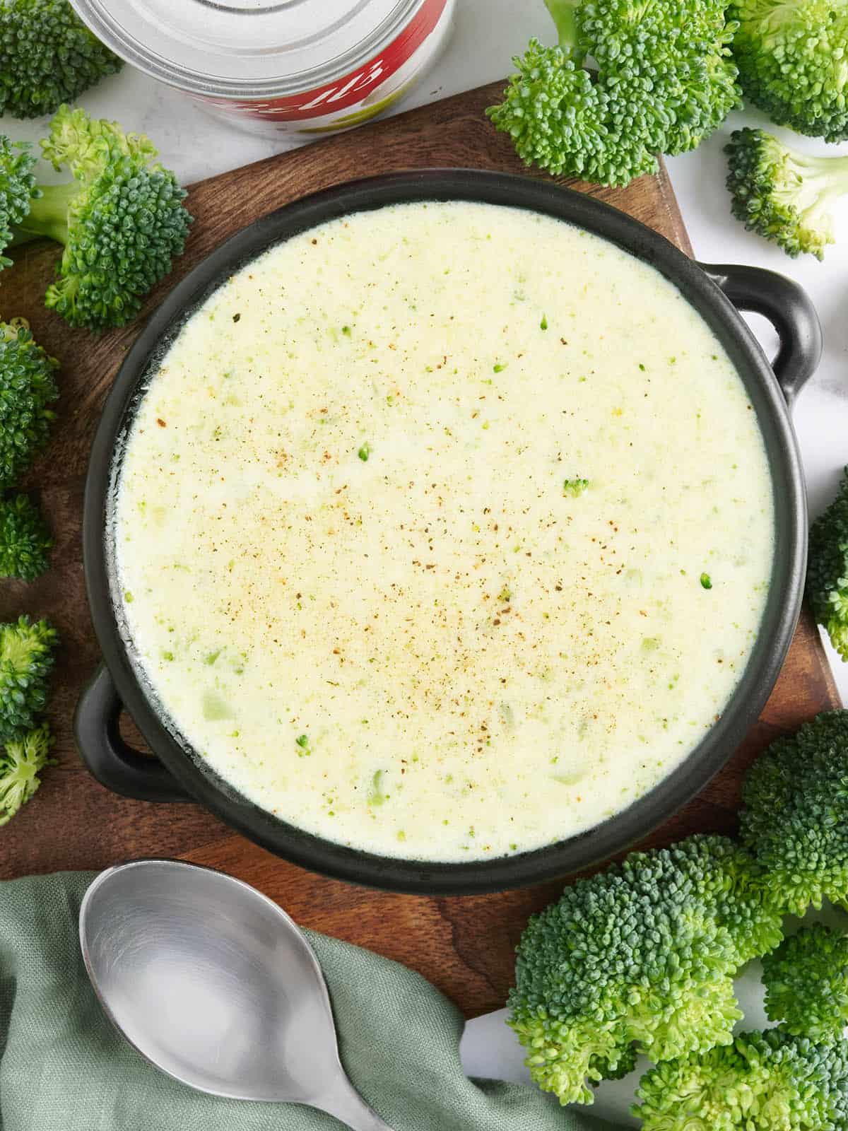 Overhead view of a bowl of homemade cream of broccoli soup.