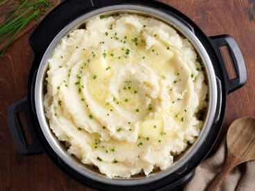 Overhead view of instant pot mashed potatoes topped with herbs.