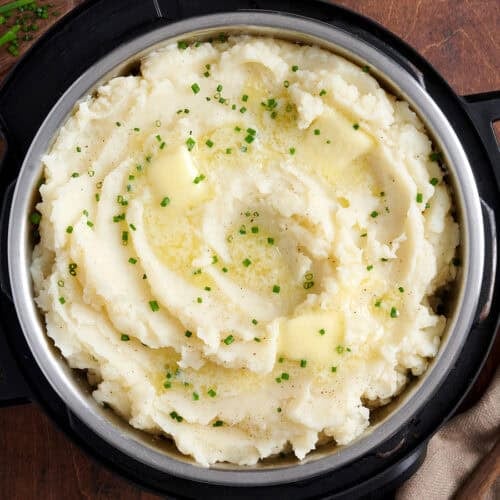 Overhead view of instant pot mashed potatoes topped with herbs.