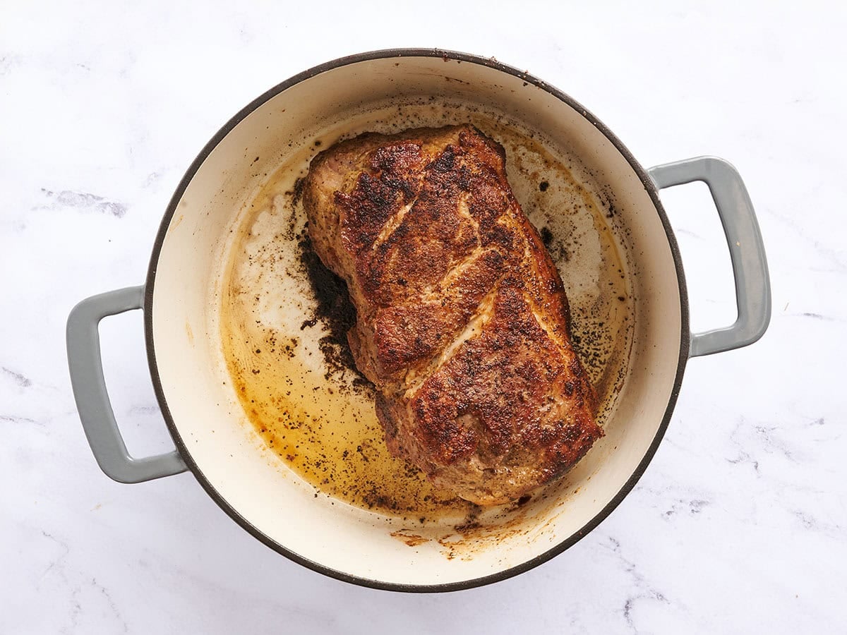 Seared pork butt in a dutch oven.