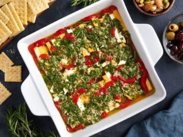 Overhead view of a pan of marinated cheese.