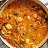 Pot of marry me chicken soup with a ladle in it.