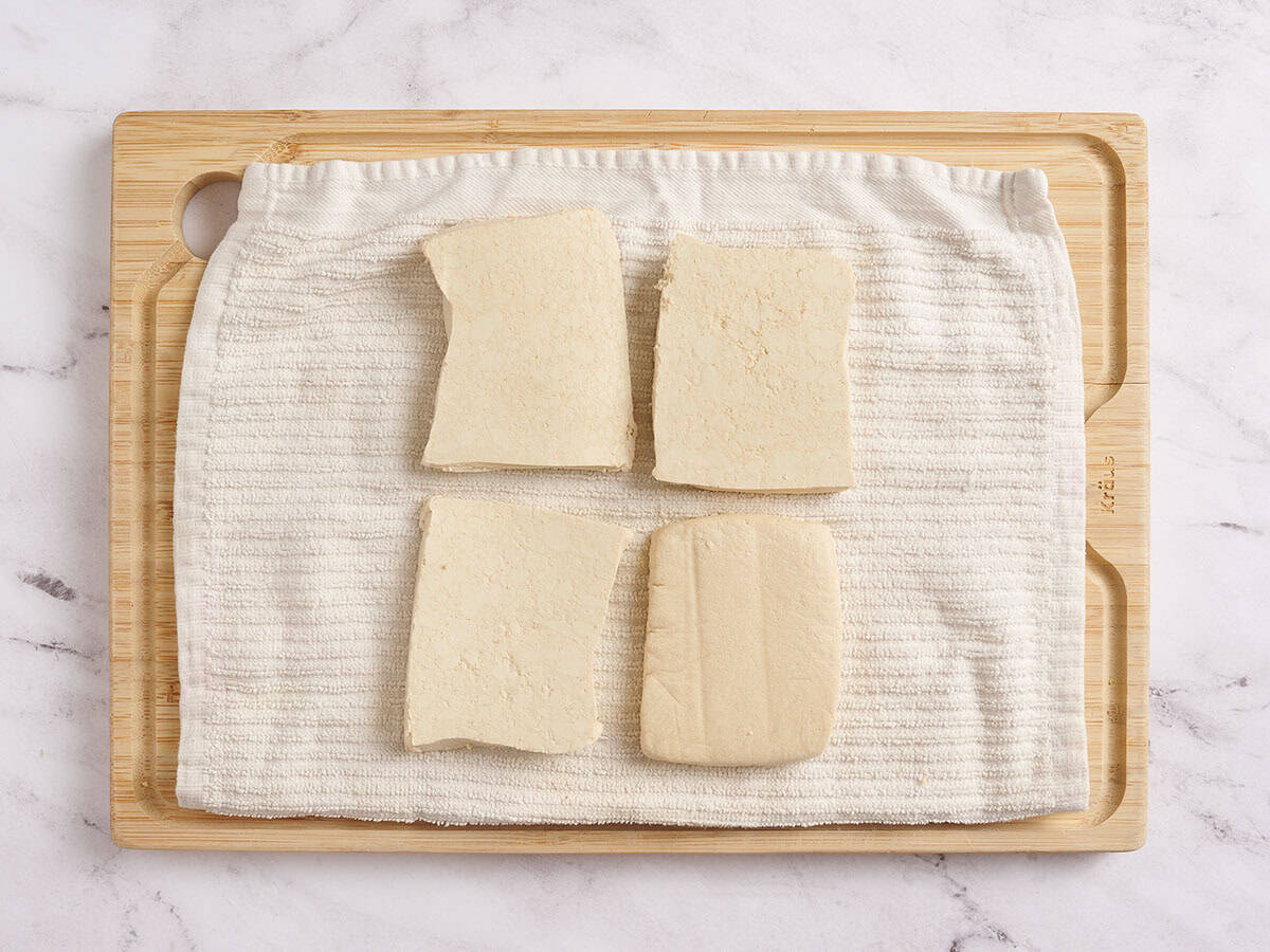 A block of tofu cut into four.