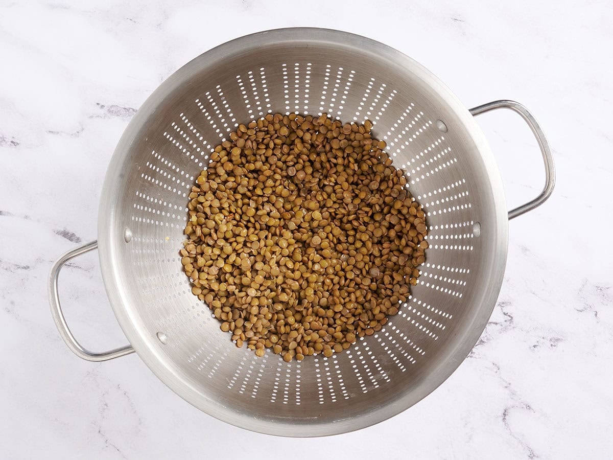 Cooked lentils in a colander.