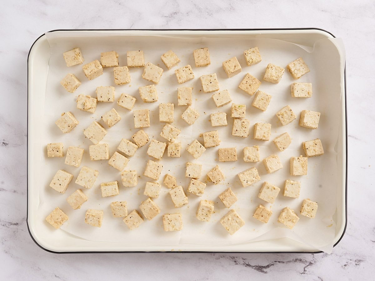 Tofu cubes on a baked tray.