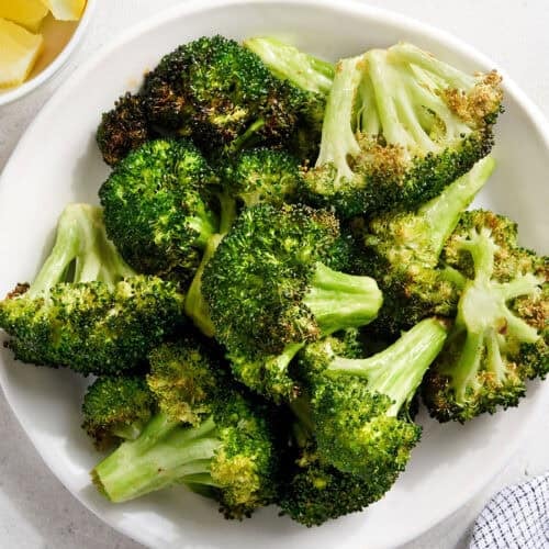 Overhead view of air fryer broccoli on a plate.