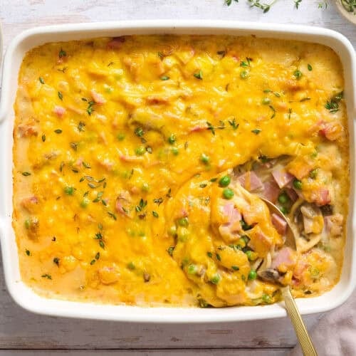 Overhead view of ham tetrazzini in a casserole dish with a spoon.