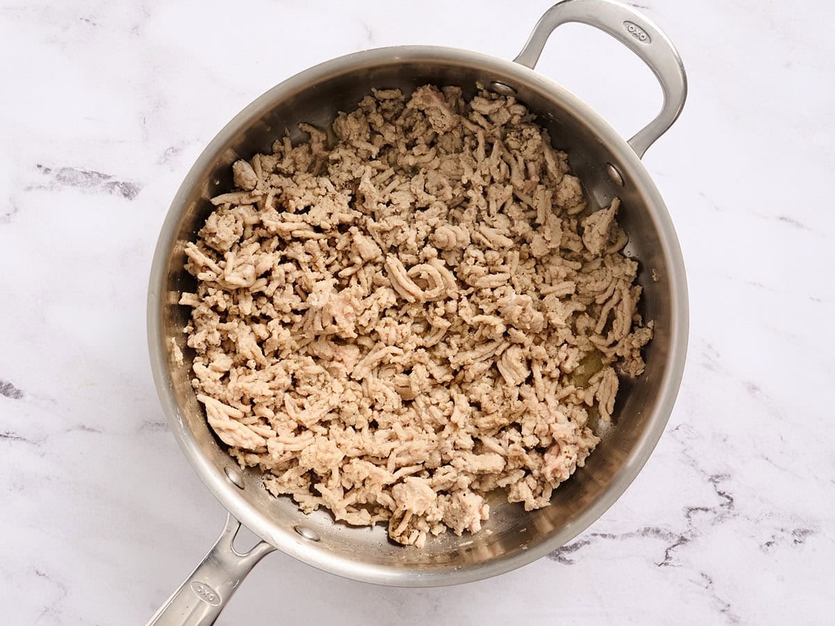 Browned chicken in a skillet.