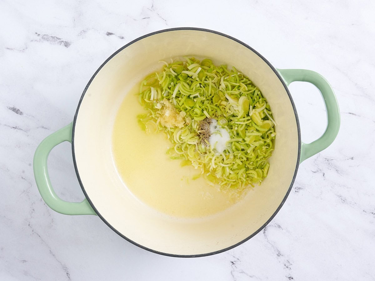Melted butter and oil in a pot with minced leeks and garlic.