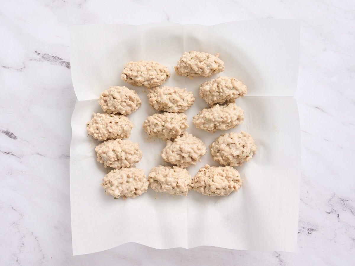 Formed chicken croquettes on a plate.