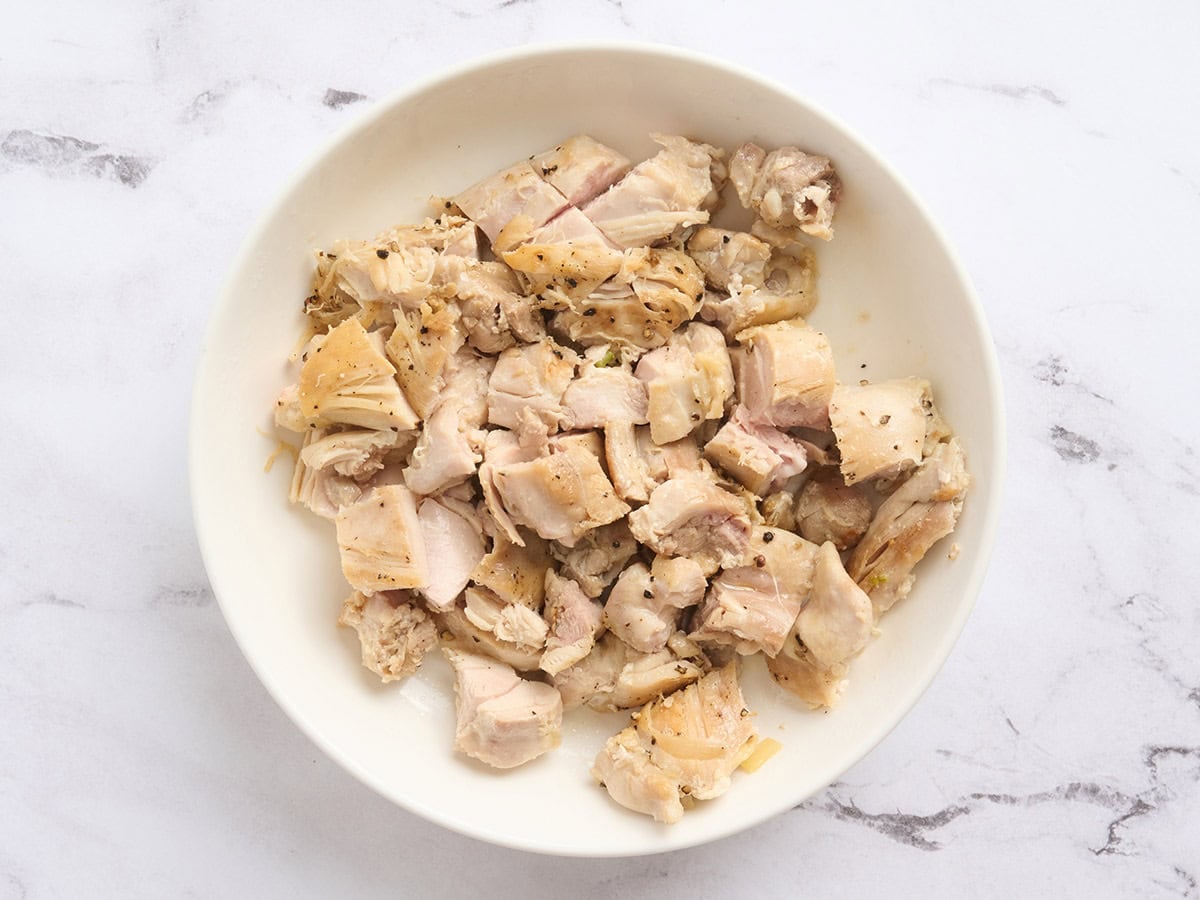 Cooked diced chicken thigh on a plate.