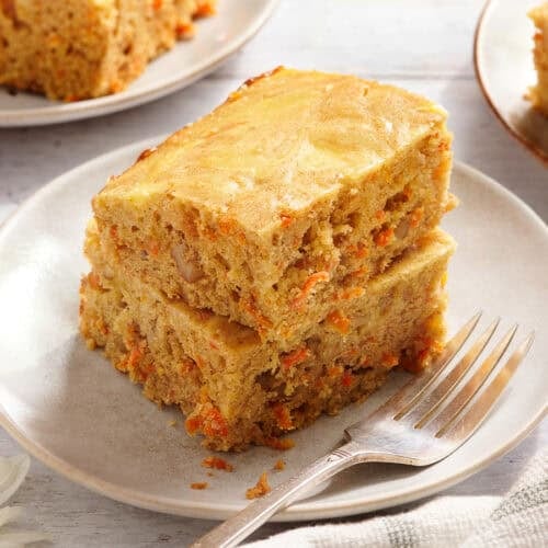Side view of carrot cake bars on a plate.