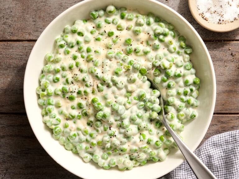 Overhead view of a bowl of homemade creamed peas.