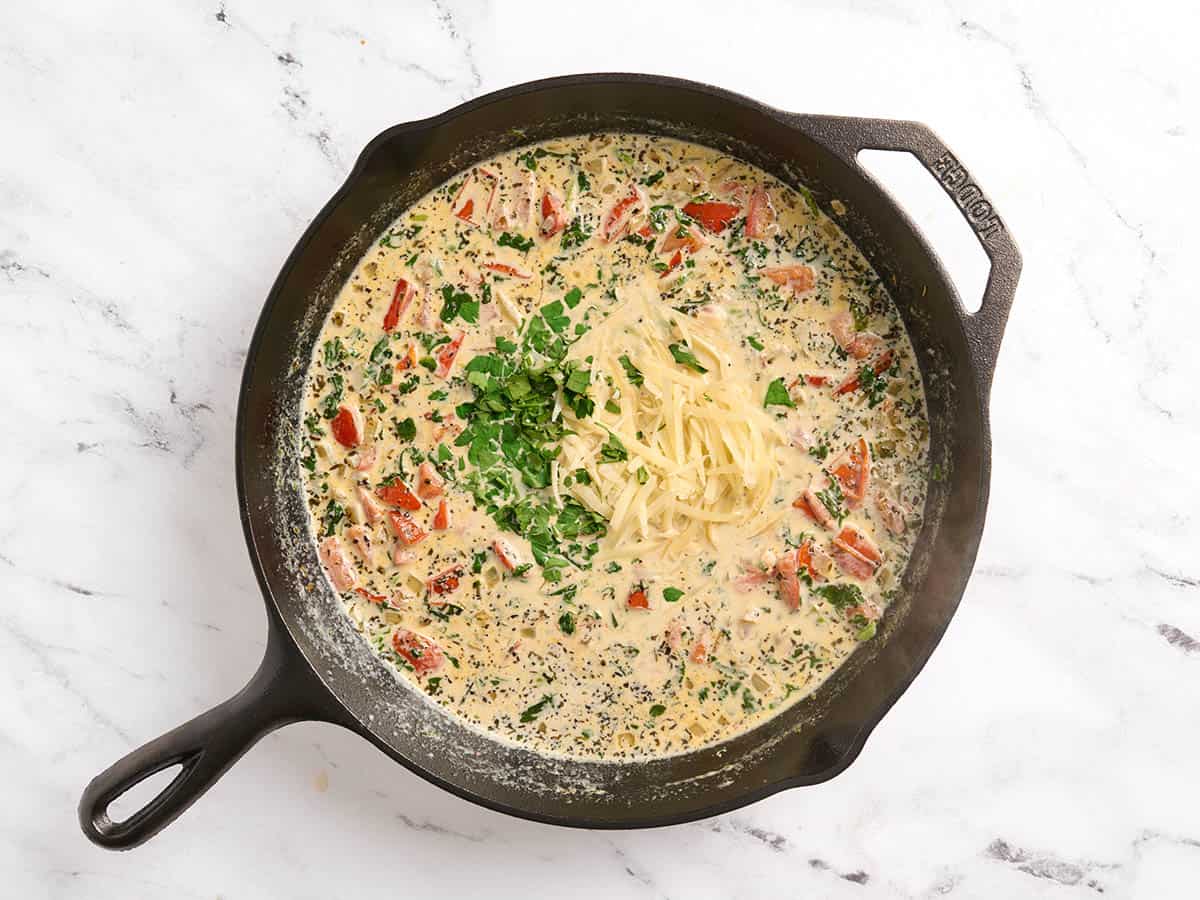 Parsley and parmesan added to a tuscan salmon skillet.