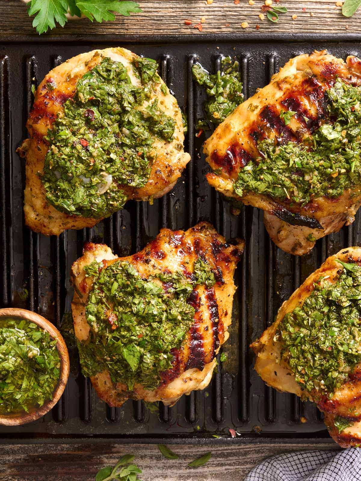 Overhead view of chimichurri grilled chicken on a grill.