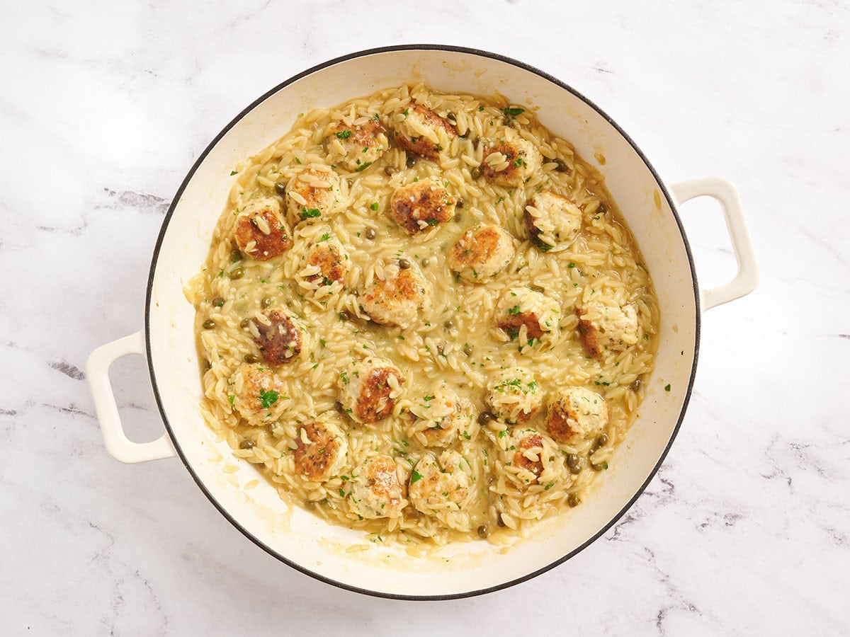 Overhead view of chicken piccata meatball and orzo skillet.
