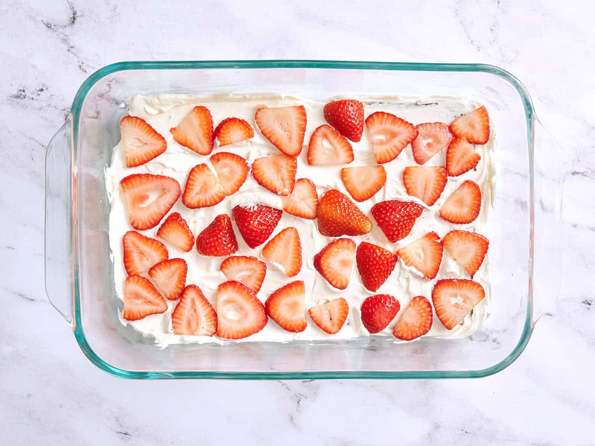 Layered strawberries in a baking dish.