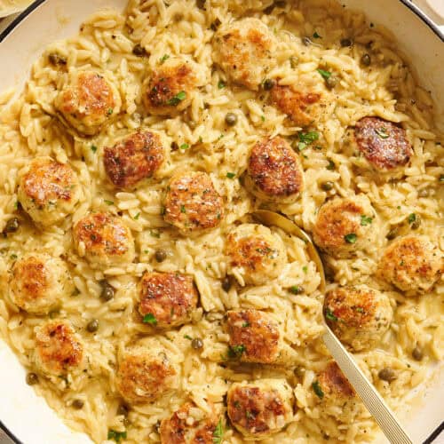 Overhead view of a chicken piccata meatball and orzo skillet.