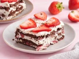 Side view of a slice of chocolate strawberry icebox cake.