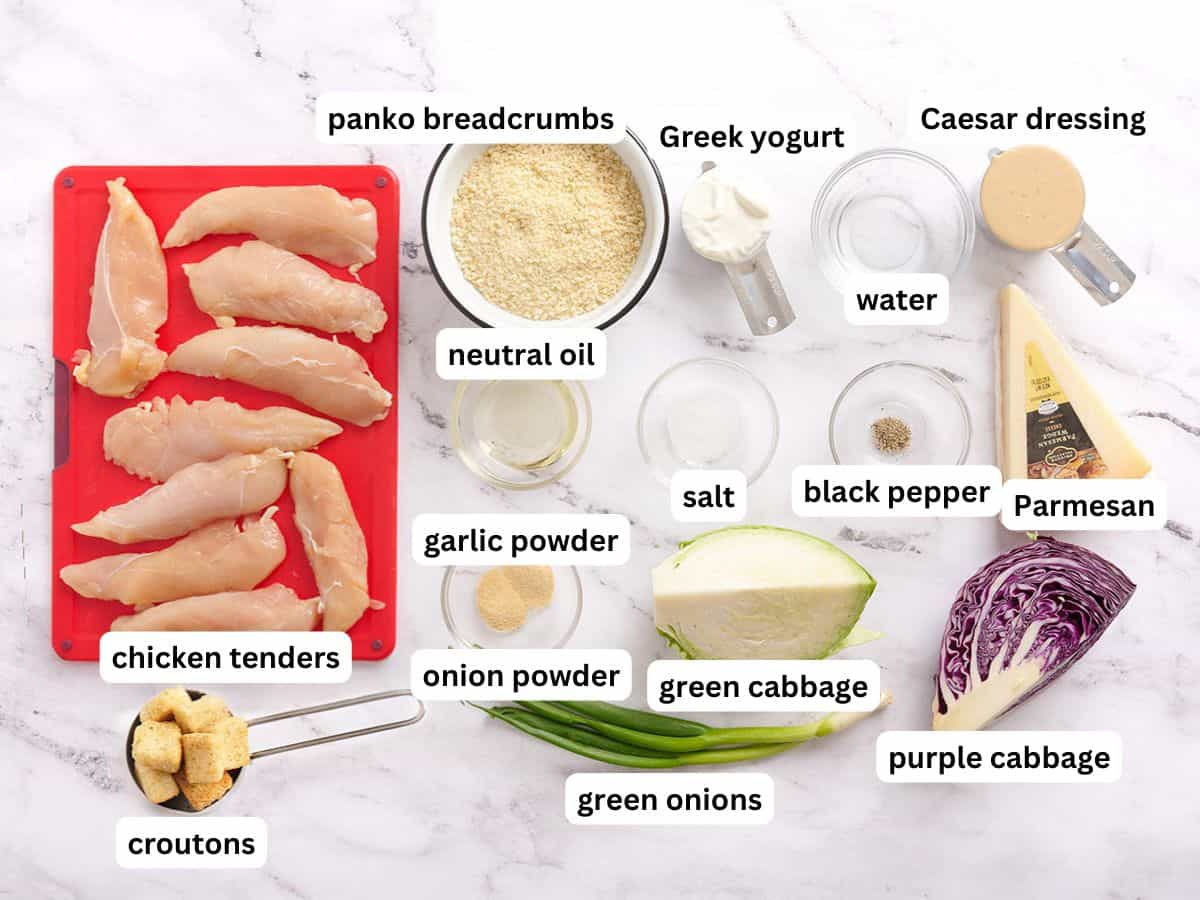 The ingredients to make Caesar slaw with crispy chicken with labels.