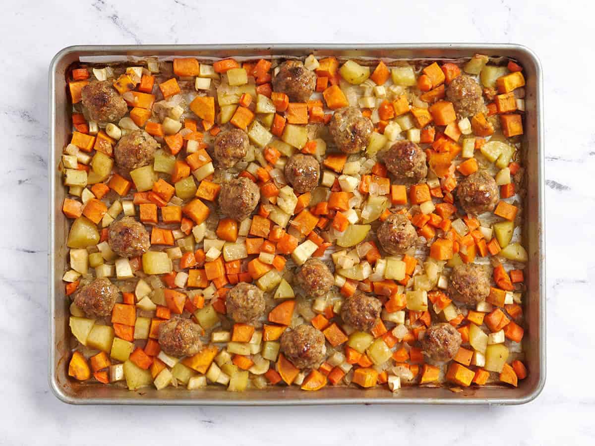 Finished sheet pan meatballs with root vegetables out of the oven.